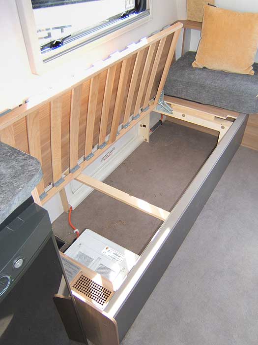 A view of the storage space beneath the front lounge seats.